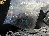 a bag of beads on a table next to a bag of beads