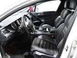 the interior of a white car with black leather seats and a steering wheel