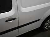a white van with a black stripe parked in a garage