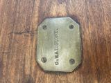 a metal tag that says madison on it on a wooden table