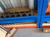 a stack of pallets sitting on a pallet rack in a warehouse