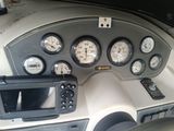 a dashboard of a boat with a lot of gauges on it
