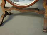 a small mirror sitting on a stand on the floor