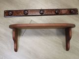a wooden shelf with a coat rack on top of it