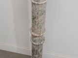 a white pedestal with a hole in the middle of it