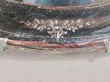 a silver tray with a mirror on it on a table