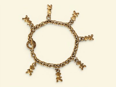 an image of a gold bracelet with flowers on a white background
