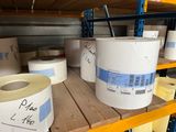 several rolls of toilet paper are stacked on a shelf in a warehouse