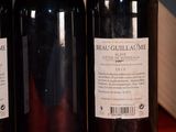 three bottles of wine sitting on a table next to each other