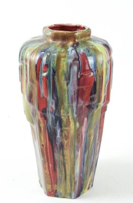 a multicolored vase sitting on a white surface