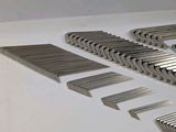 a lot of metal blades that are laying on a table