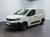 the white van is parked in a large room with a black floor