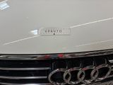 a close up of a car ' s grille with a sticker on it