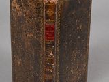 an old book that is open on a table