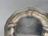 a silver plate with a handle on a table