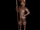 bronze statue of a man with a spear and a star on a pedestal