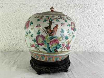 a vase that has a bird on it on a stand