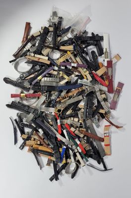 a pile of assorted hair clips on a white surface