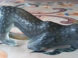 a statue of a leopard on the floor of a house