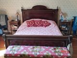 a bed and a bench in a room with a wallpapered wall