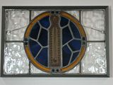 a stained glass window with a picture of a cross on it