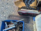 two chainsaws and a box of tools on the ground
