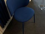 a blue chair sitting in front of a window in a room