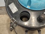 a blue bowl sitting on top of a metal drum