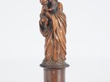 a bronze statue of a woman holding a child on a pedestal