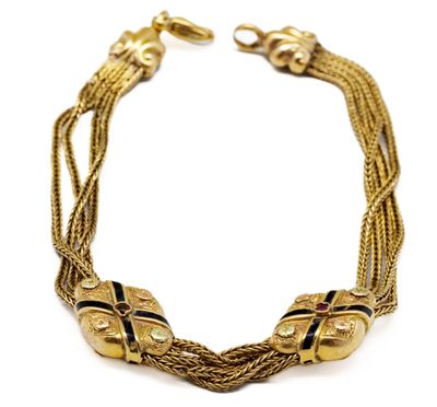 une image représentant un bracelet en or orné de perles noires sur fond blanc