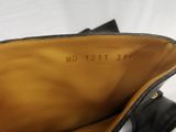 the bottom of a pair of black leather shoes with a white background