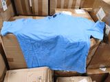 a pile of boxes and a blue t - shirt on the ground