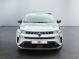 the front view of a silver car in a white room