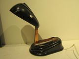 a black lamp that is sitting on a white table