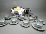 a lot of cups and saucers sitting on a table