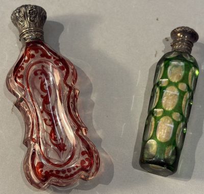 two glass bottles that are sitting next to each other
