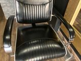 a black office chair with a yellow tag on it
