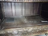 a wooden bench that has a sign on the back of it