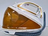 a yellow and white steam iron sitting on a white surface