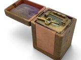 a small wooden box with a key inside of it