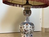 a lamp that is sitting on a table with a lamp shade on it