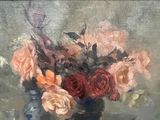 a painting of flowers in a vase on a easel