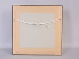 an empty picture frame with a string wrapped around it on a table