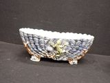a ceramic bowl with a bird on it on a black surface