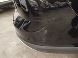 a close up of a car ' s bumper with a reflection on it