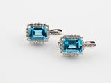a pair of blue topaze and diamond earrings