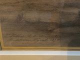 a picture of a painting on display in a glass case