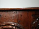 a wooden mantle with a clock on top of it