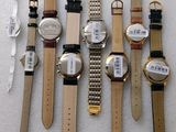a lot of watches that are sitting on a table