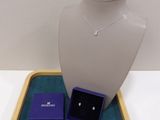 purple jewelry tray with a necklace, earrings, and ring on it